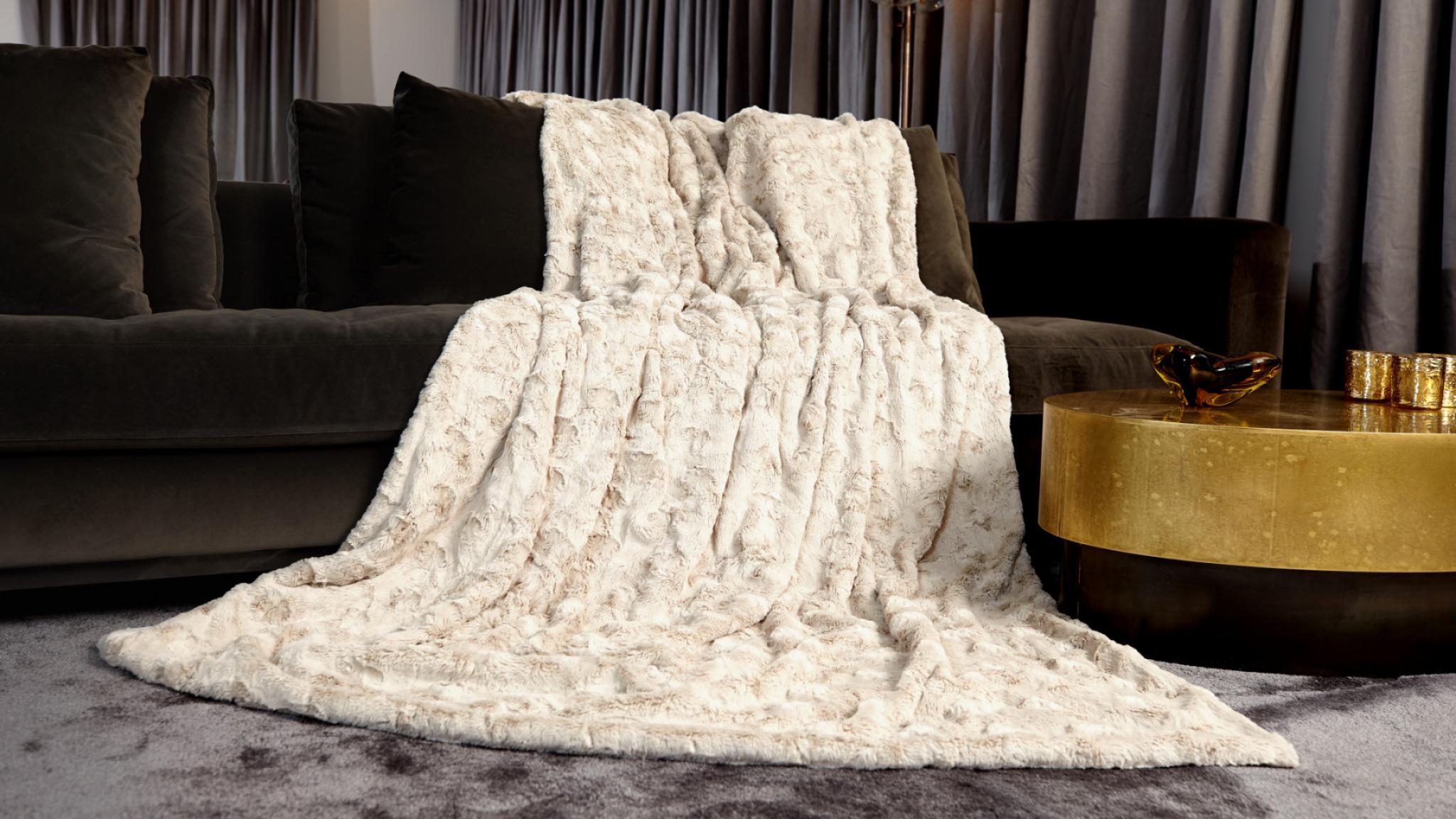 Sehr weiche und kuschlige Webpelzdecke auf dem Wohnzimmer Sofa Farbe Sandstein Beige 